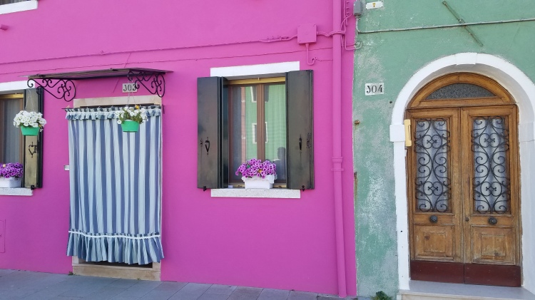 Pink and green building in Burano, Italy